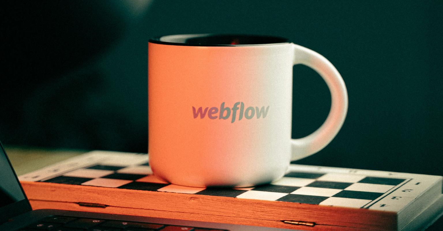 coffee cup with Webflow logo on it